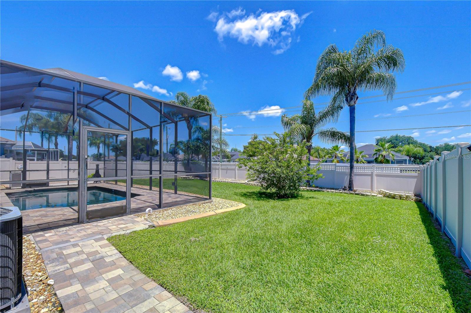 Private outdoor oasis framed by lush palm trees.