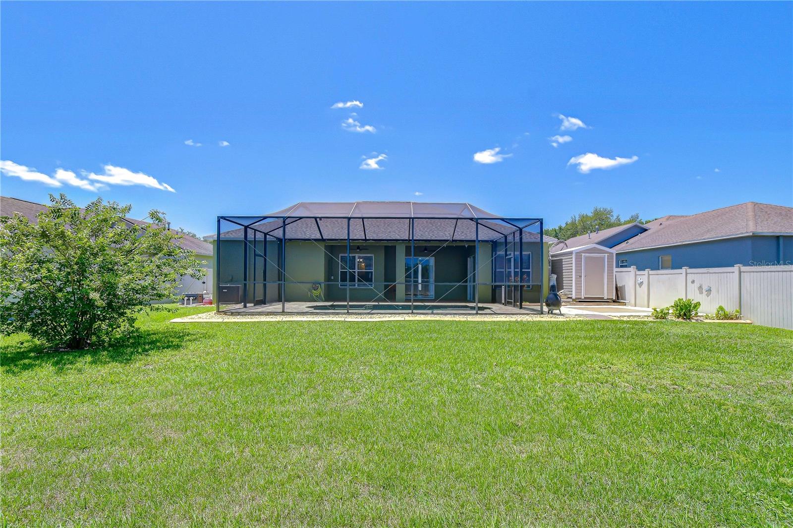 Beautiful rear exterior showcasing the lanai and pool area.