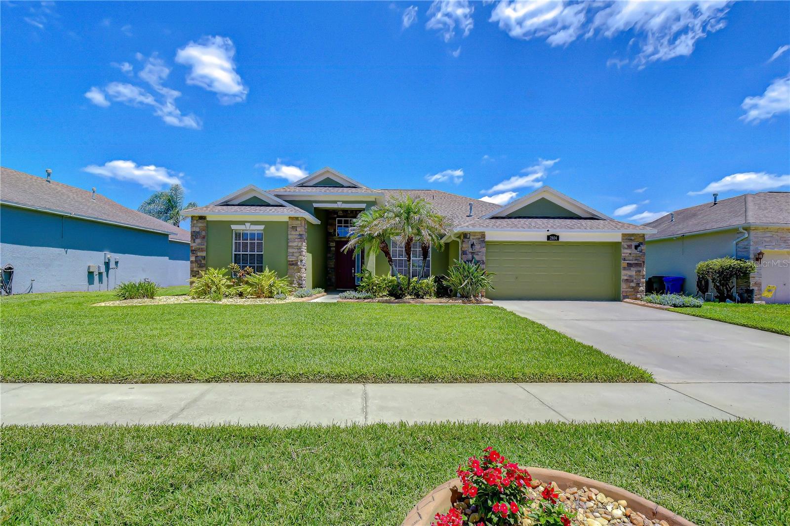 Spacious driveway and well-maintained landscaping.