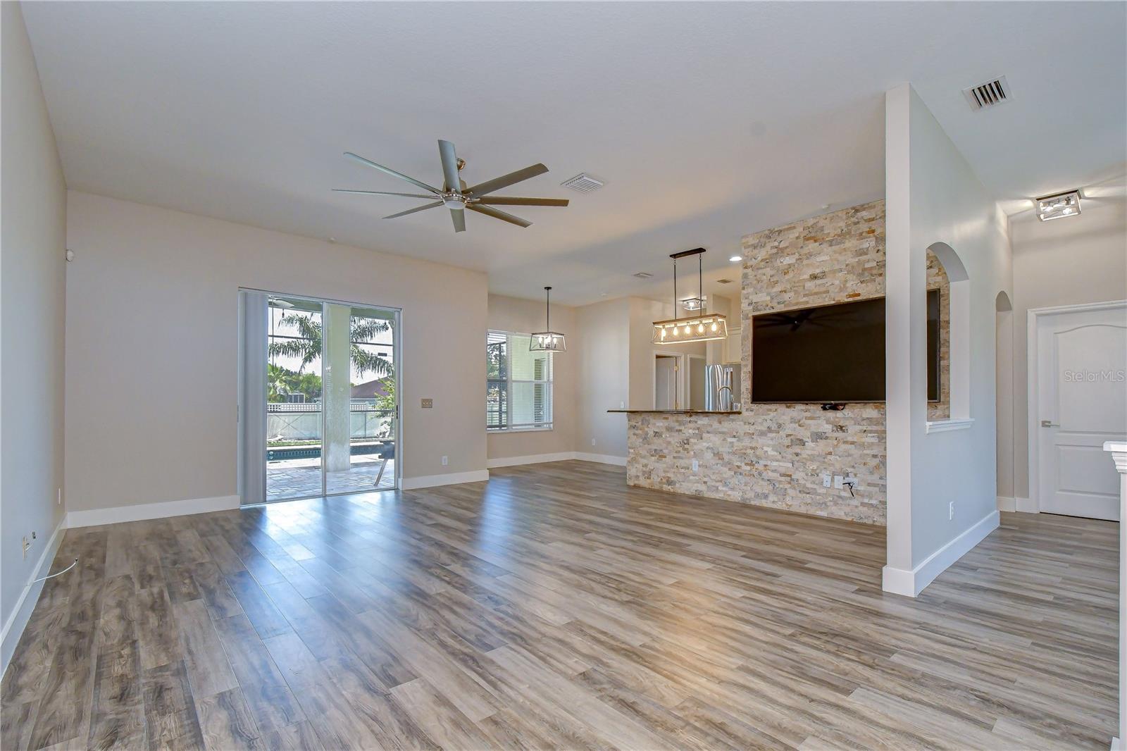 Spacious main living area featuring a striking stone accent wall.