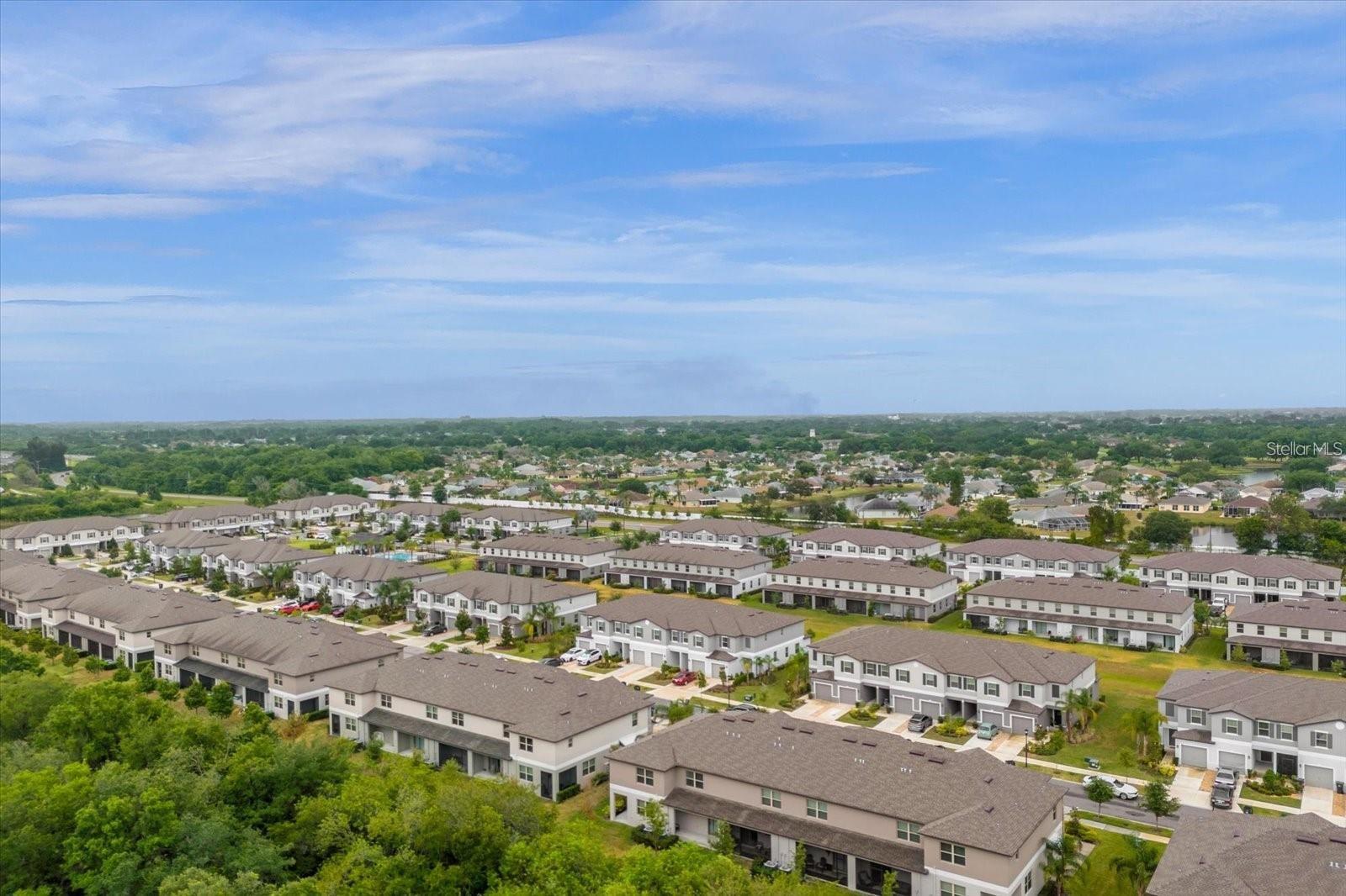 Aerial view showing green space behind home