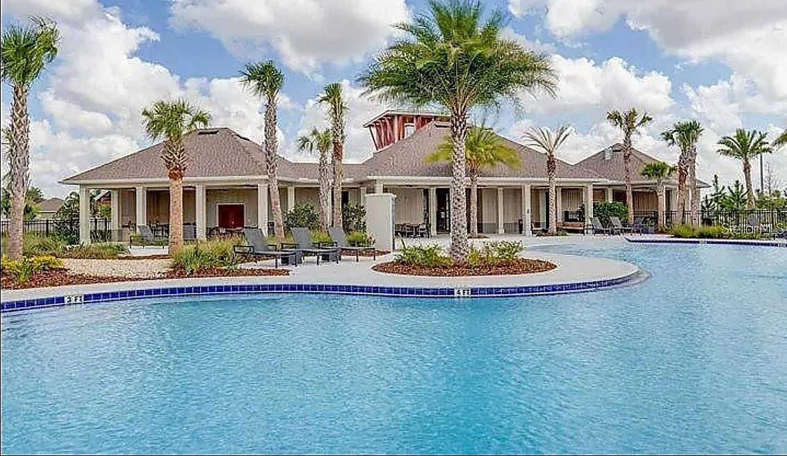 Pool view with clubhouse backdrop