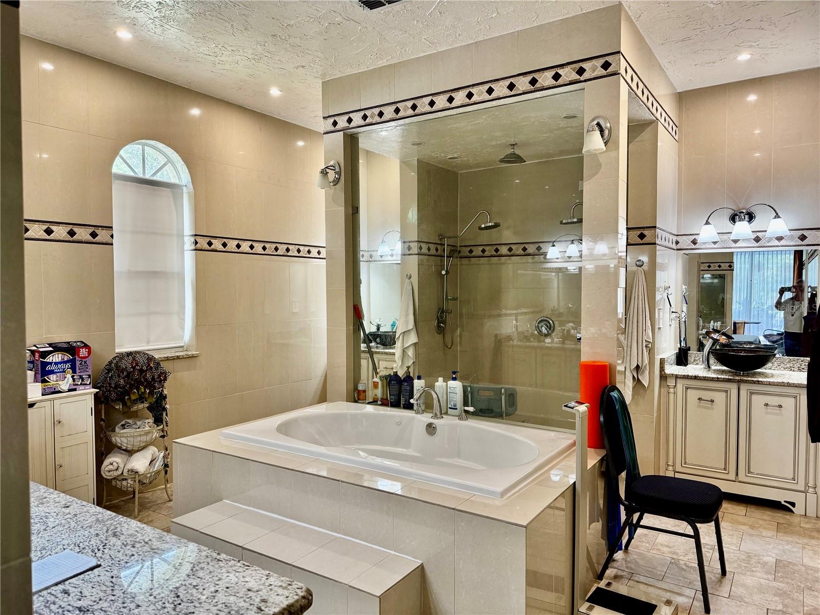 Master Bath with tile walls separate vanities