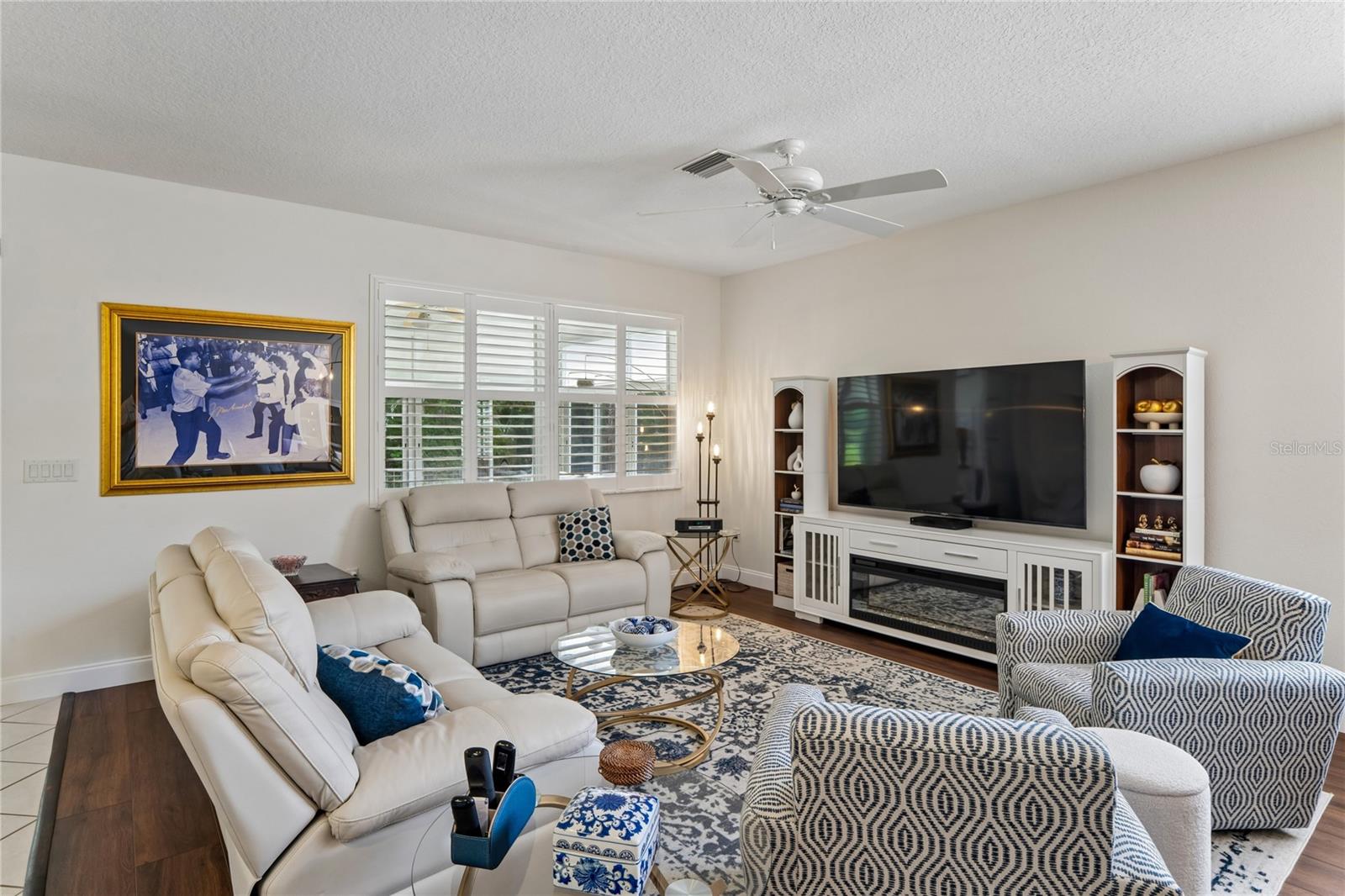 LARGE SCREEN TV IS ATTACHED TO THE WALL AND WILL REMAIN.  DECORATIVE LOUVERED SHUTTERS IN EVERY ROOM