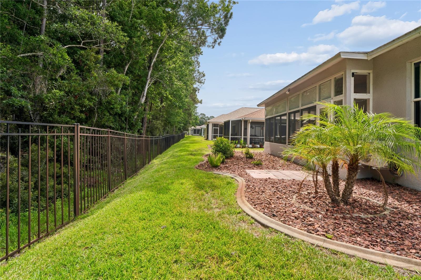 BAUTIFULLY LANDSCAPED AREA IN REAR OF HOME