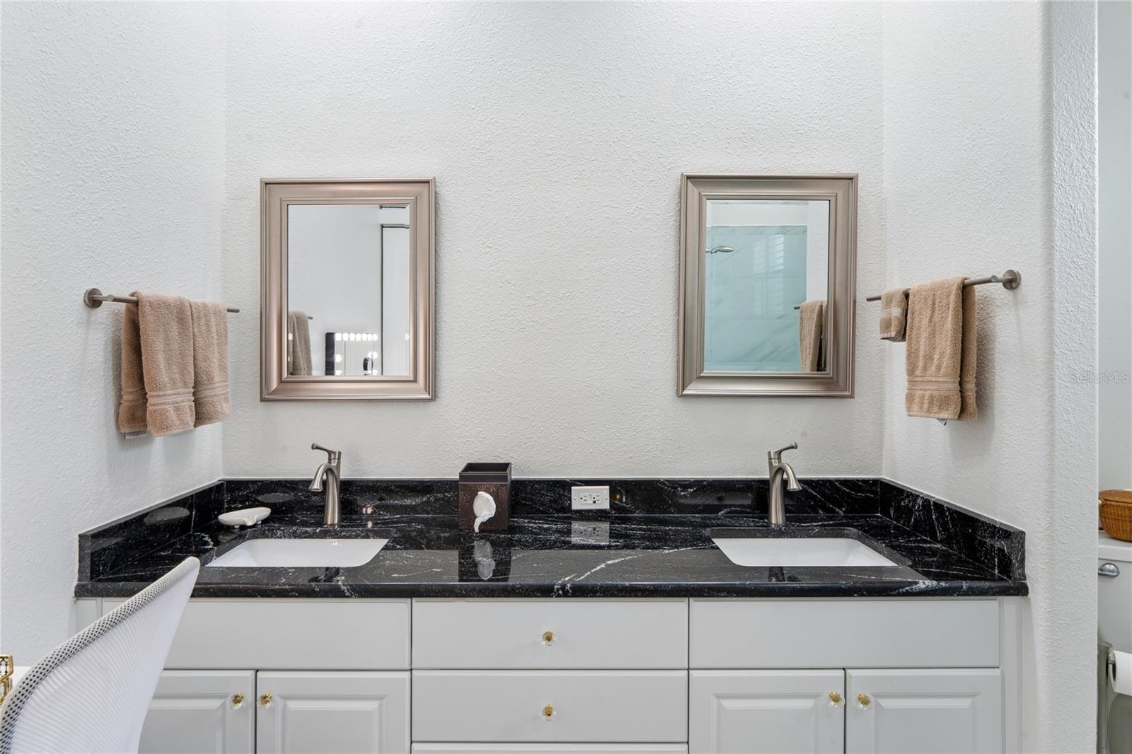 DOUBLE SINK VANITY WITH GRANITE AND NEWER FAUCETS.