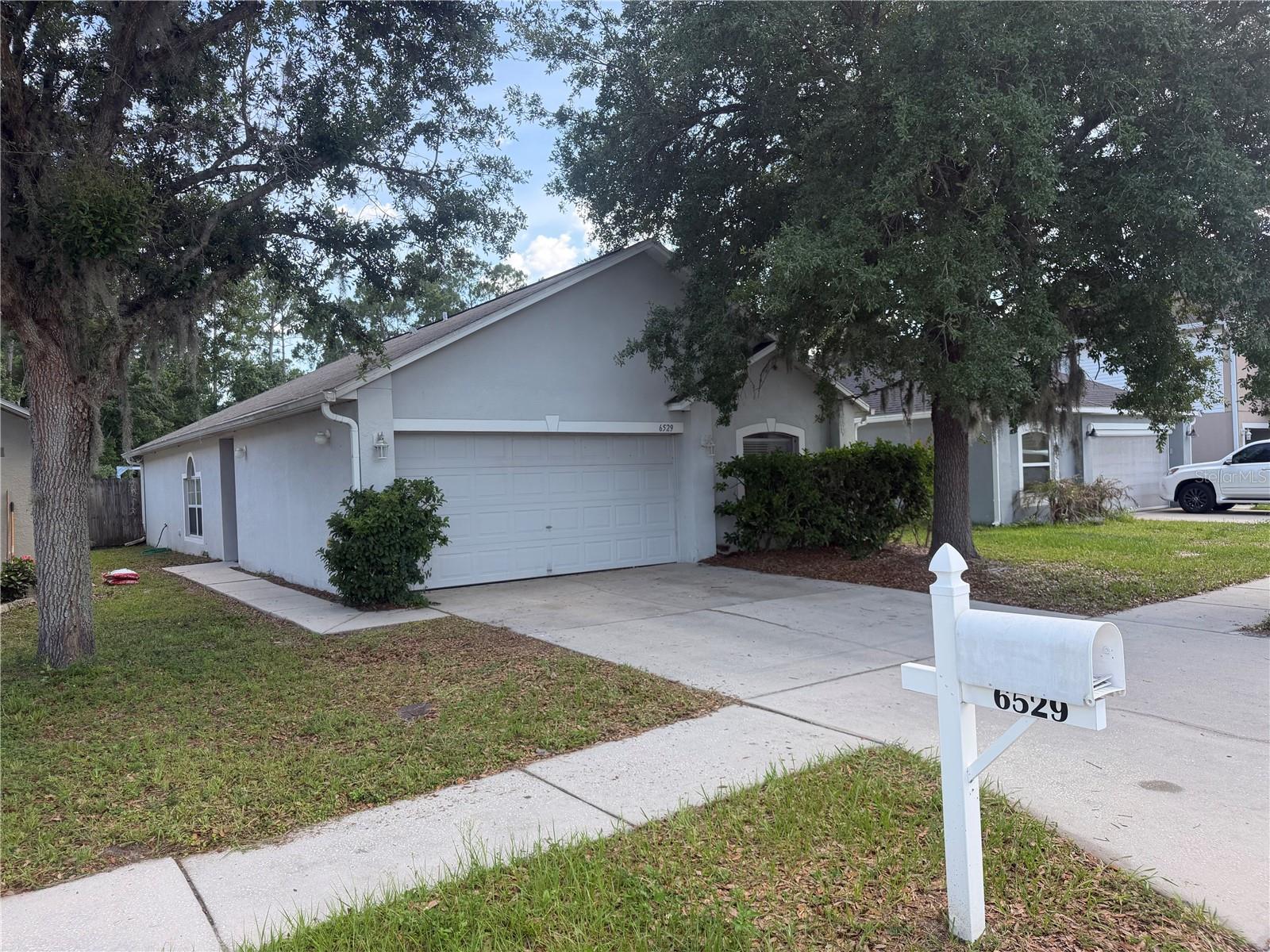 side view of the front of the home with the front door at the end of the walkway