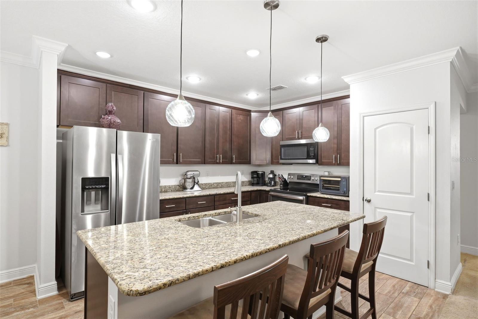 Spacious kitchen with granite countertops and island.