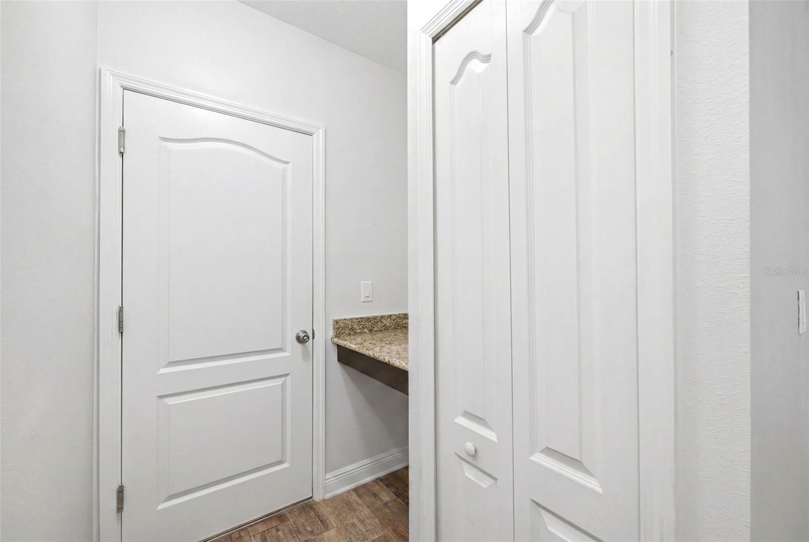 Desk and extra storage leading to oversized 3-car garage.