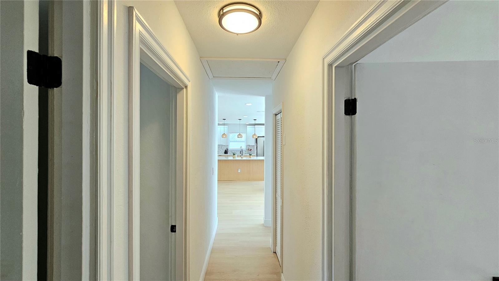 Cell Phone photo. Master Suite 2 is located through the right door. Bedroom 4 is located directly across. Bedroom 3 is also located on left. Bath 2 is located at end of hallway on right.
