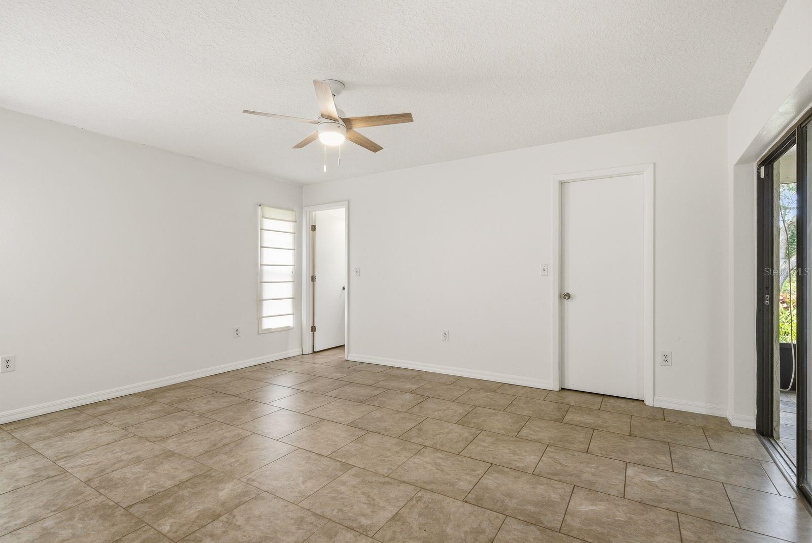 Primary bedroom, primary bathroom, walk in closet & sliders to exterior patio