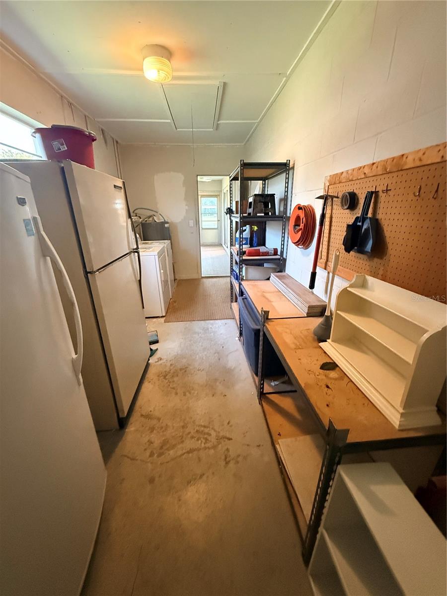 large utility room with extra refrigerator and stand up deep freezer