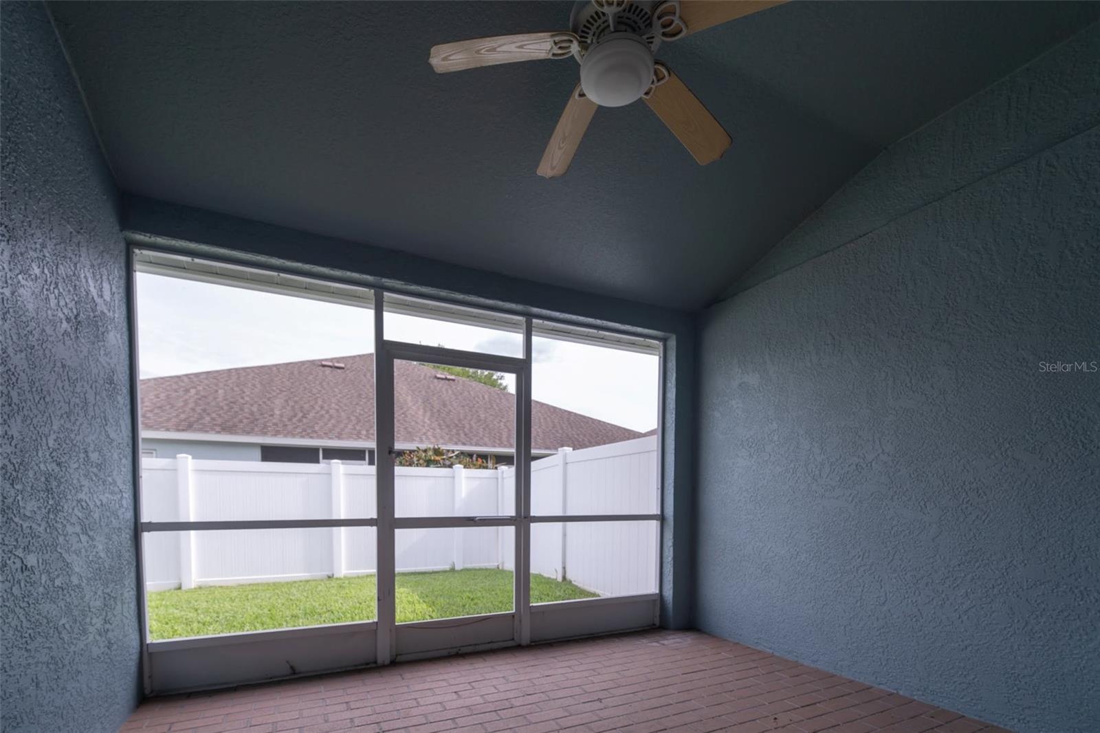 Screened and Covered Patio overlooking Fenced rear yard.