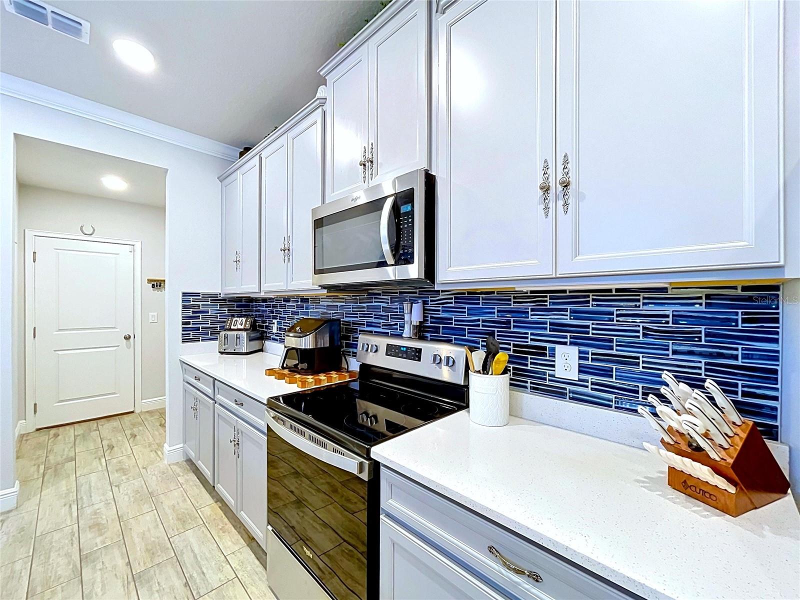 Thoughtful upgrades elevate this space, from the elegant cabinetry hardware to the eye-catching backsplash and expansive prep areas. Every detail was carefully selected to blend style with everyday functionality.