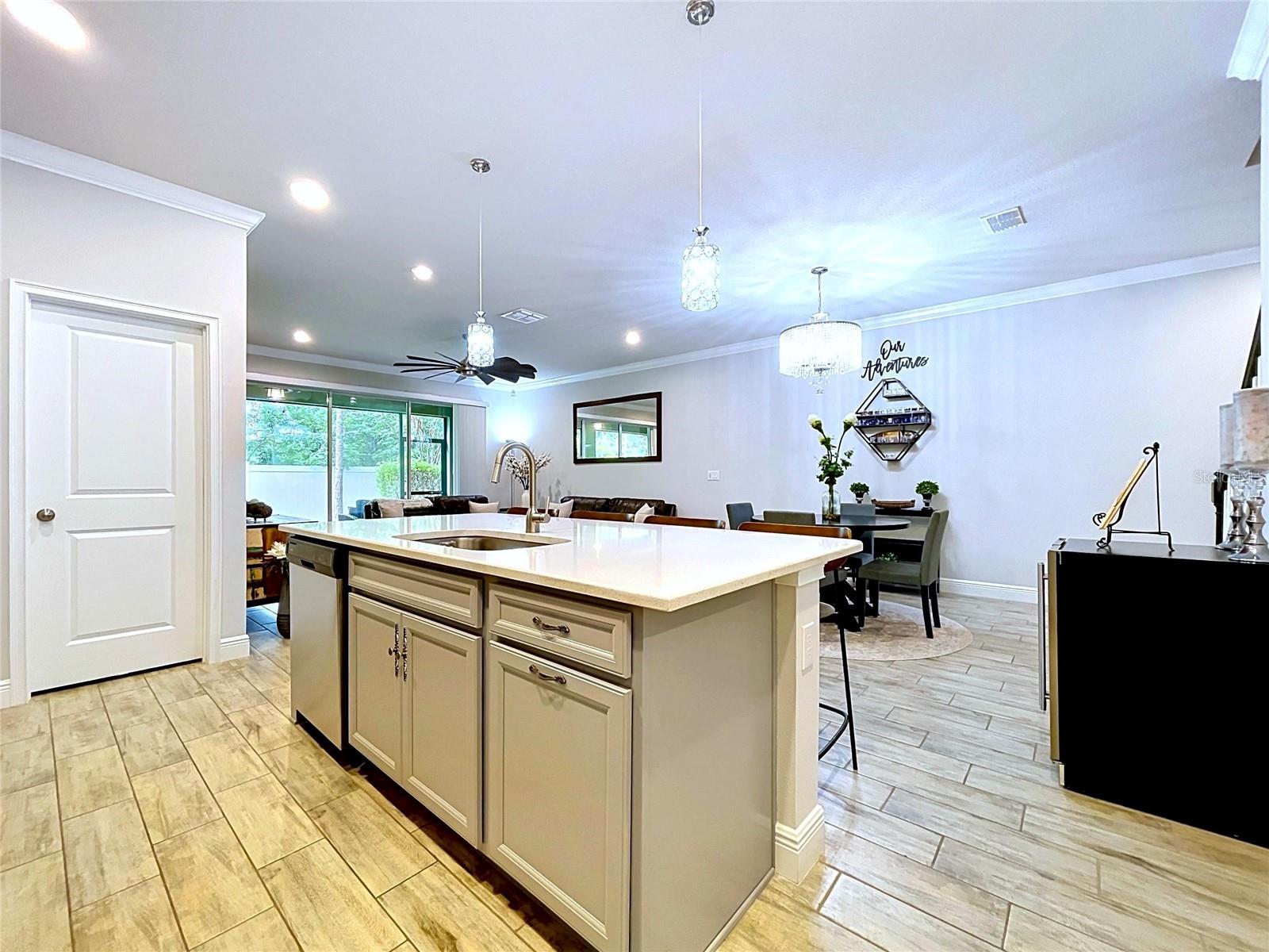 Gather, dine, and entertain around the oversized island featuring ample seating, built-in sink, and beautiful quartz surfaces. It's the perfect centerpiece for both casual mornings and holiday celebrations.