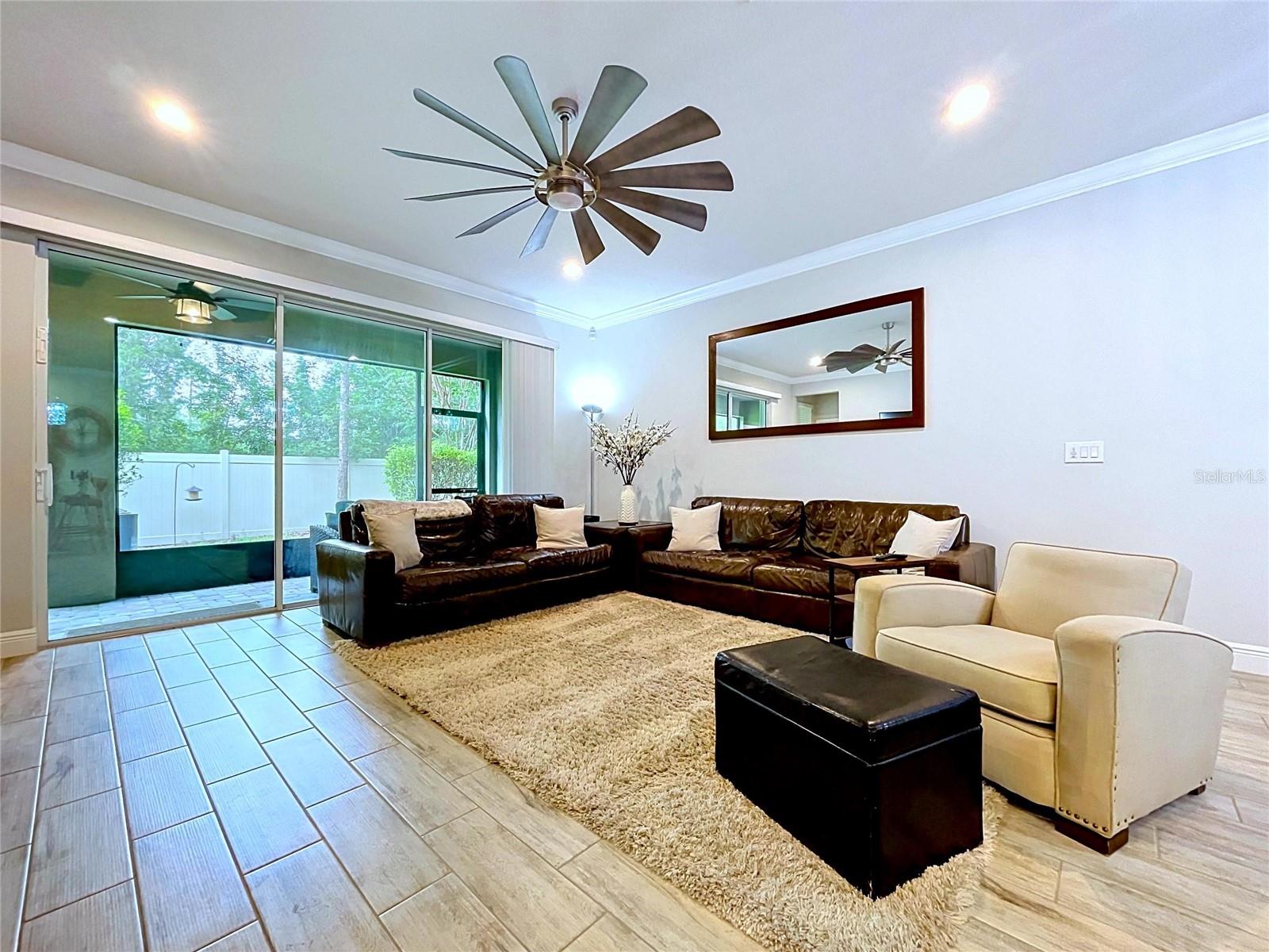 Large sliding glass doors fill the living space with natural light and create a seamless transition to the covered screened lanai, extending your living and entertaining space outdoors