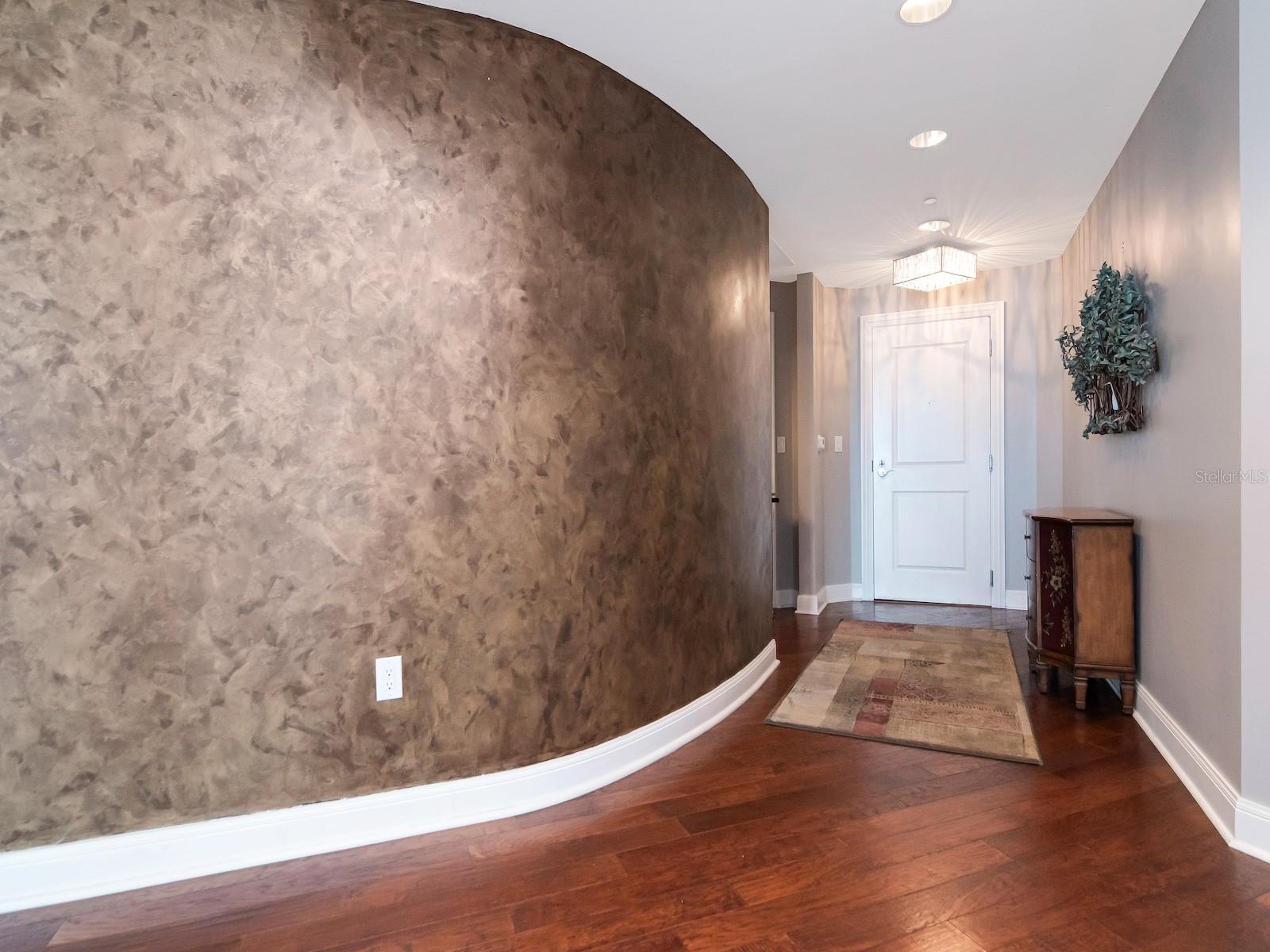 Entry with curved wall detail.