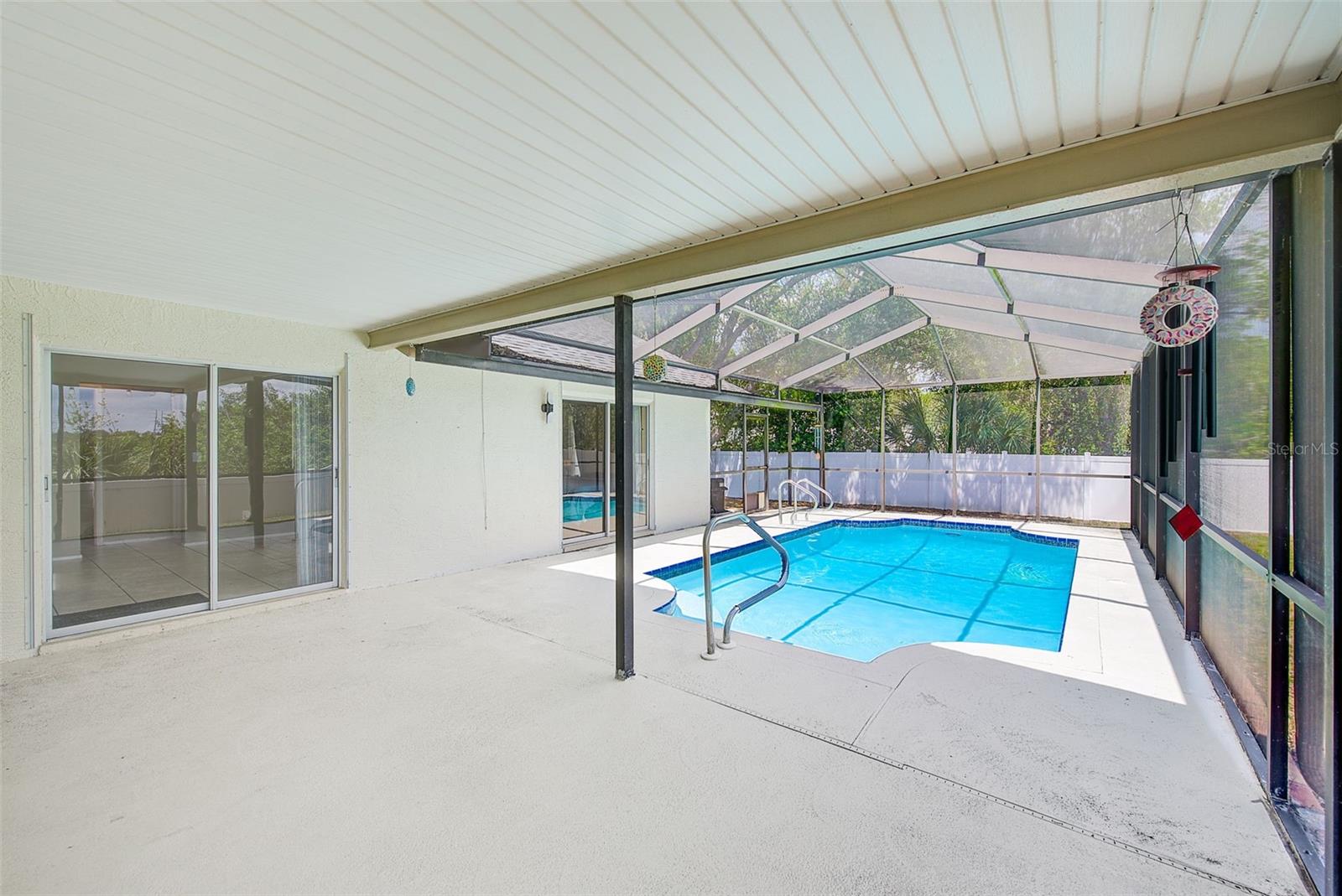 View of pool deck and inground pool