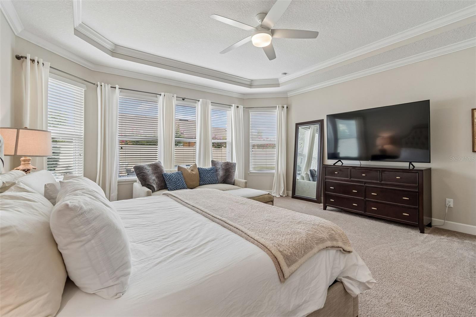 Primary Bedroom with Trey Ceilings and crown molding