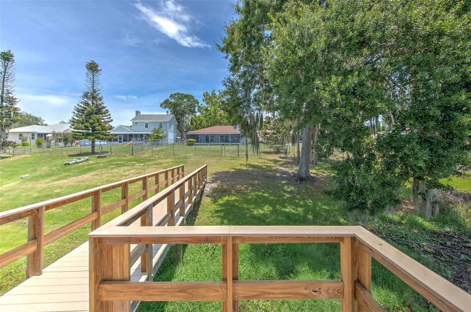 view of back of home from newer dock with handrails