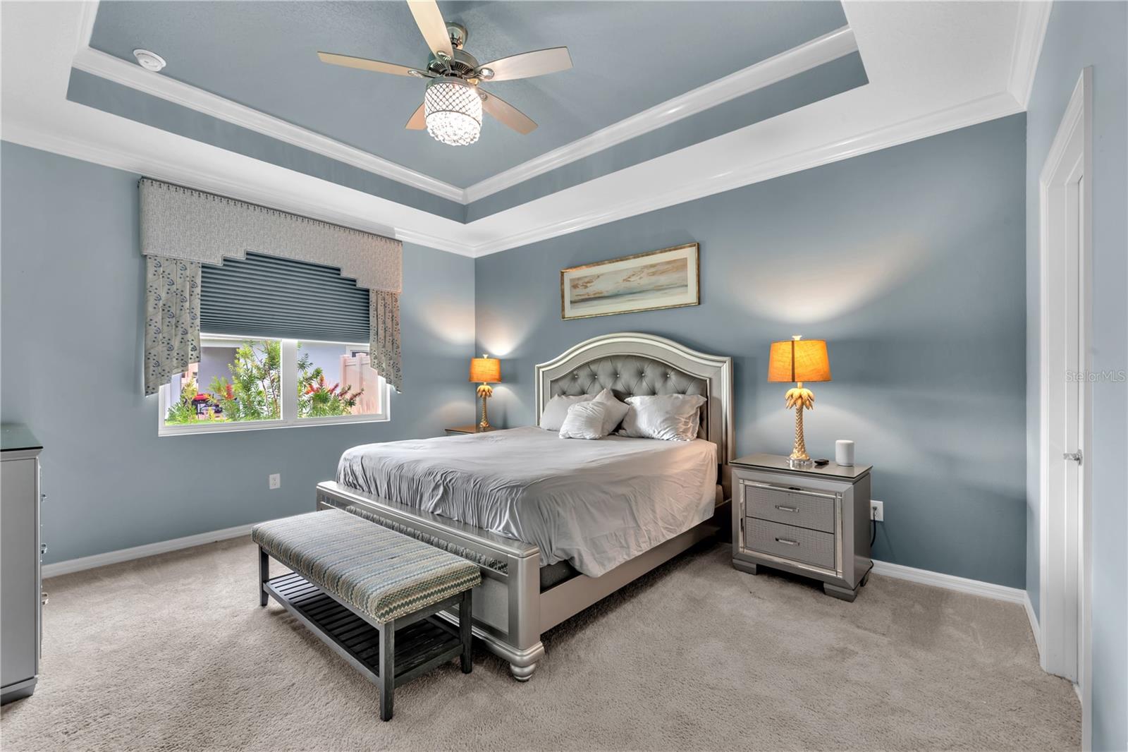 The spacious primary bedroom is a private retreat with a large walk-in closet, stunning tray ceiling and a luxurious en-suite bathroom.