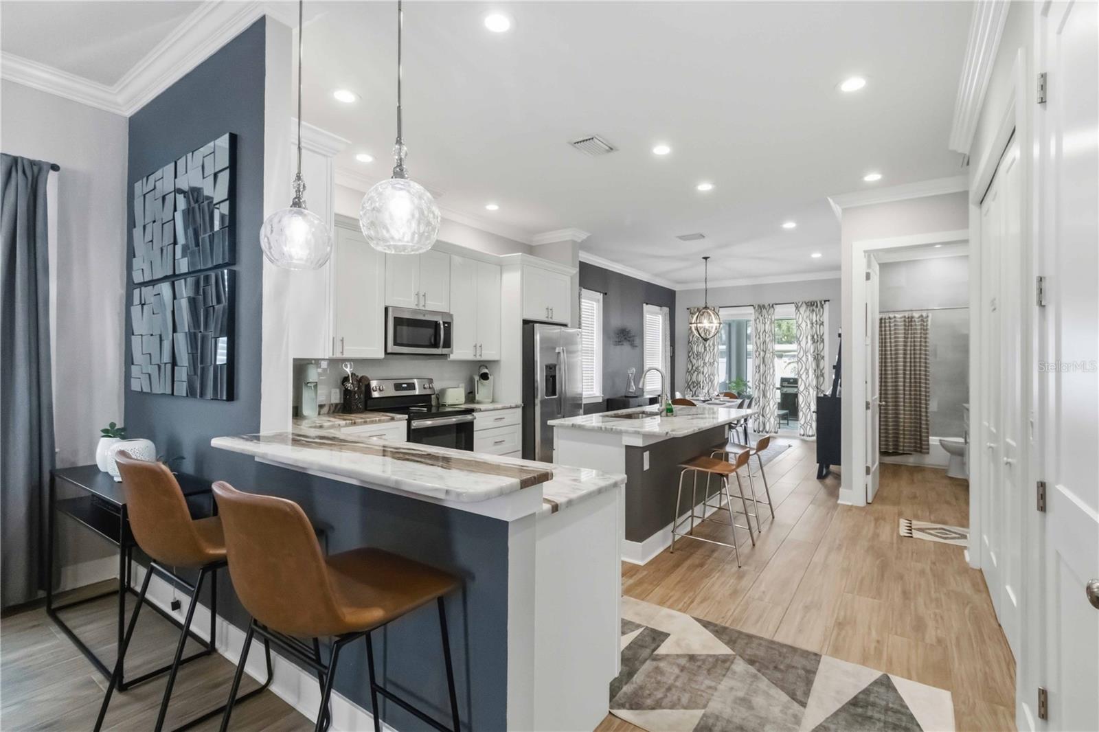 An open connection between the living room and kitchen that keeps everyone together