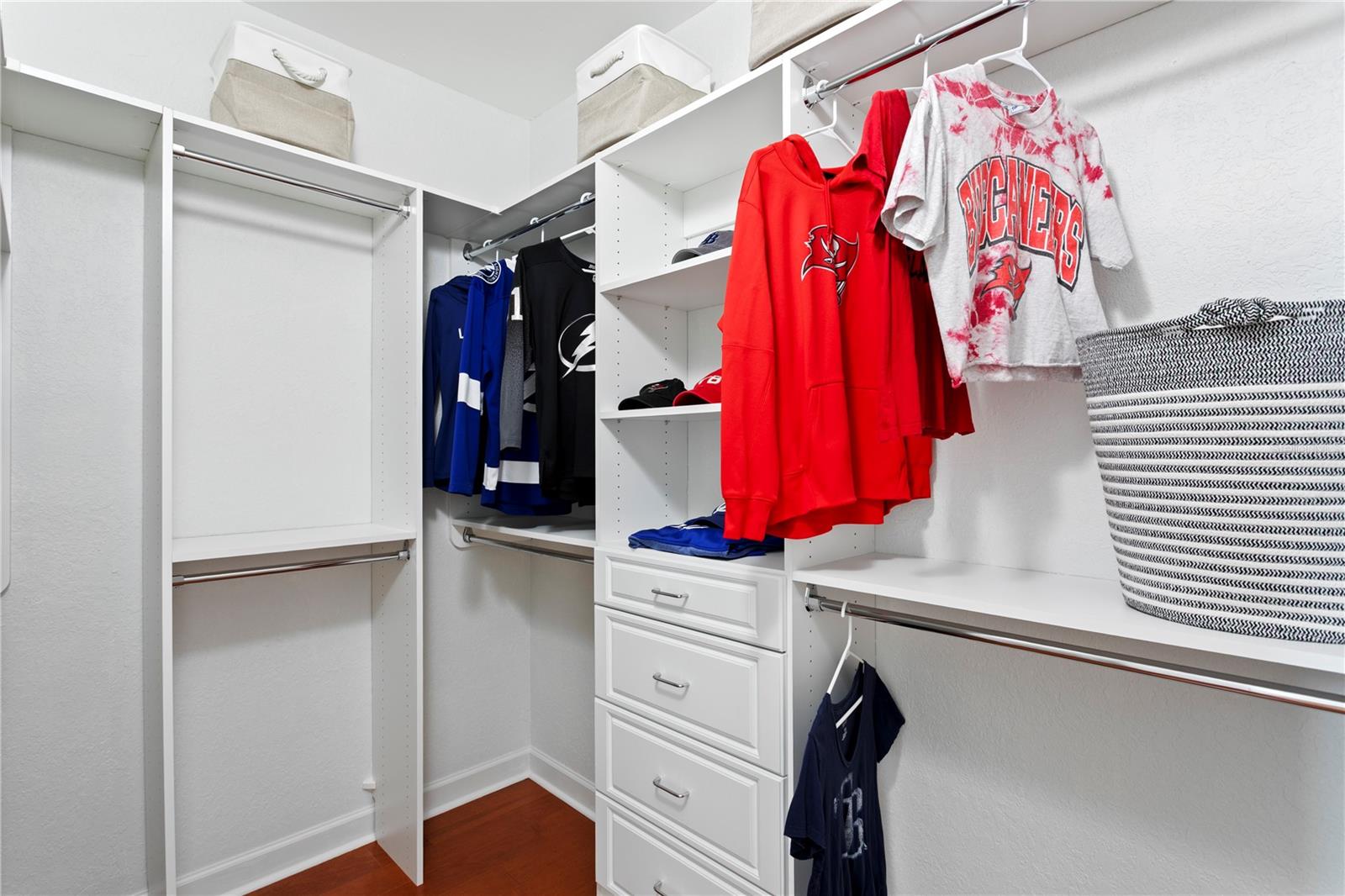 Custom built closet organizers in walk in closet