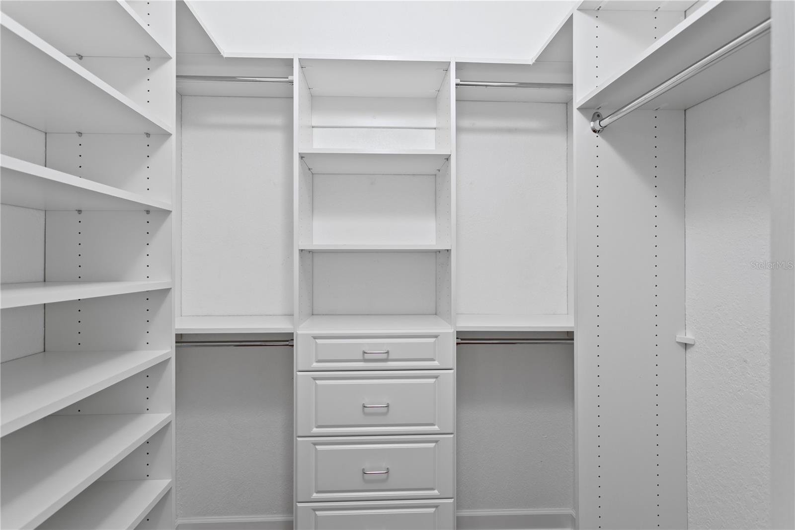 2nd Bedroom walk in closet with custom closet organizers