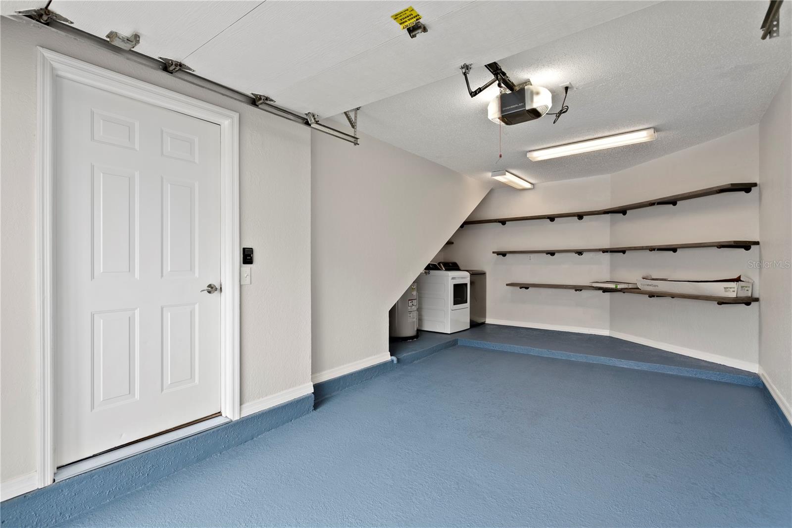 A rare and valuable highlight is the private, attached one-car garage—not commonly found at this price point—complete with built-in shelving for exceptional storage.