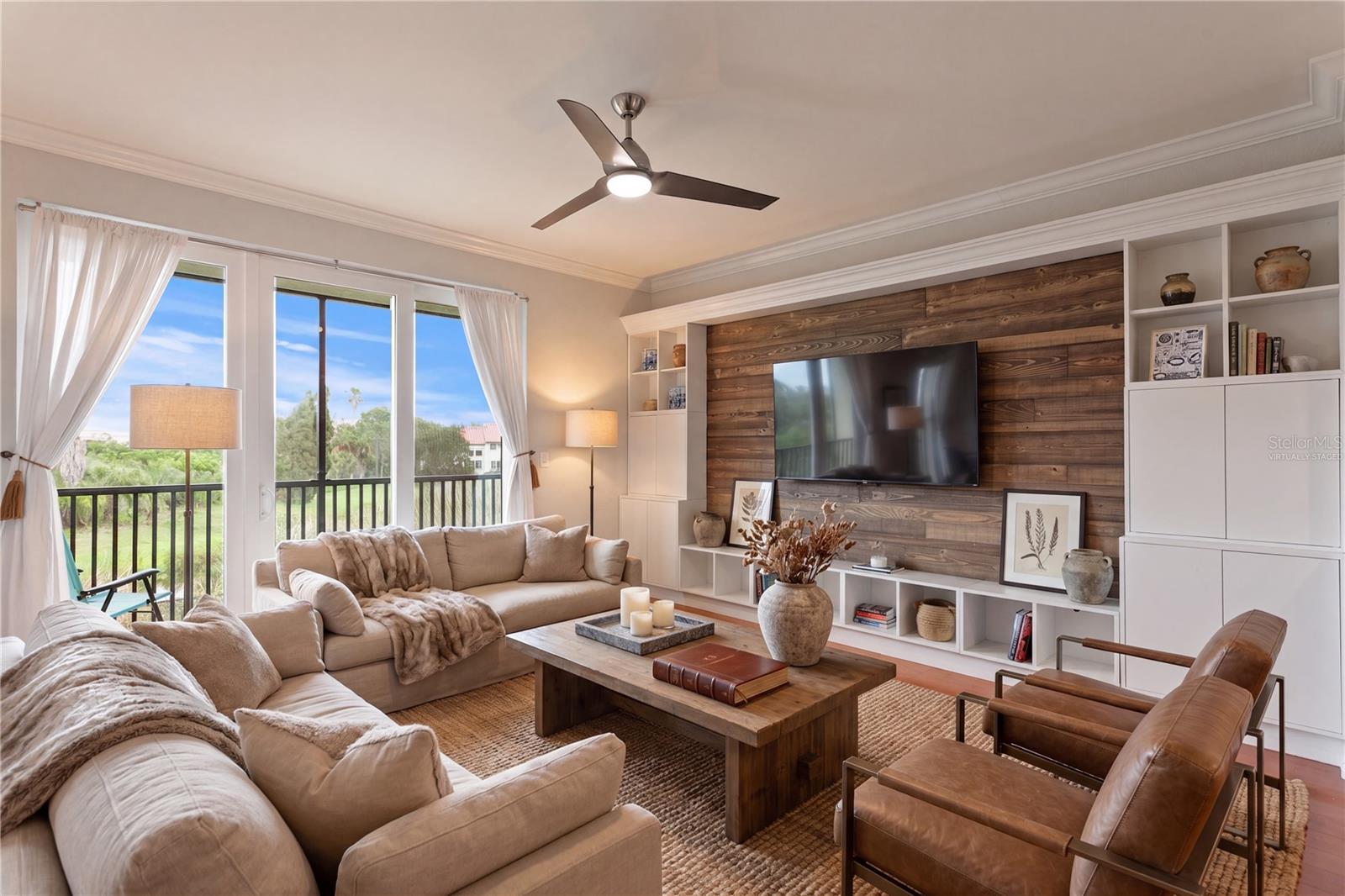Virtually staged image - The spacious great room features a custom feature wall with built-ins, creating warmth and an idealbackdrop for your television.