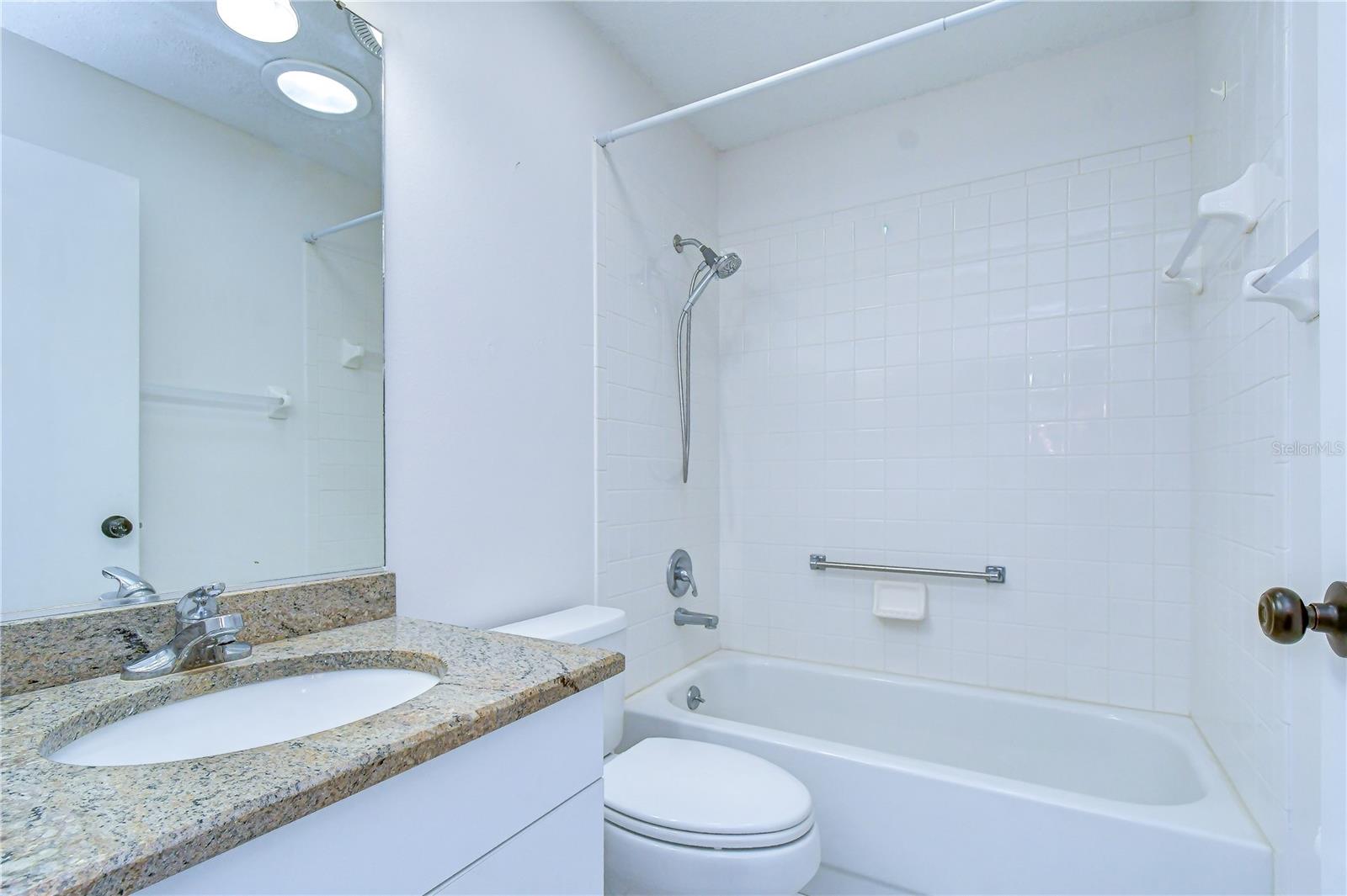 Well-appointed secondary bathroom conveniently serving guests.
