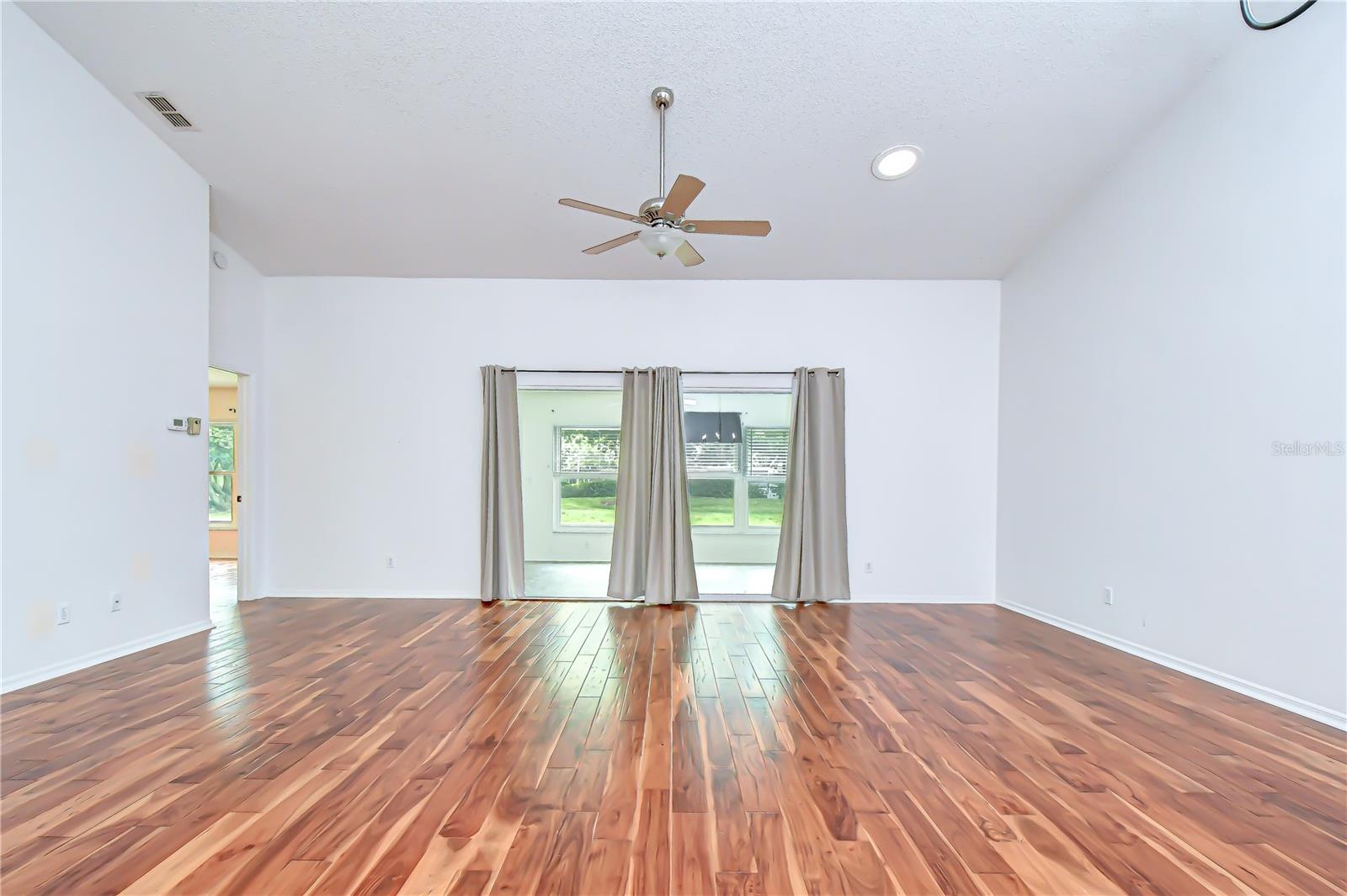 Spacious open-concept living area with soaring volume ceilings.