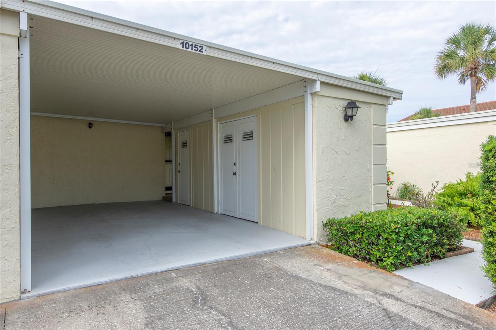 Large over space Carport with 2 storage rooms. One larger room for bicycles, storage, workshop area and refrigerator.