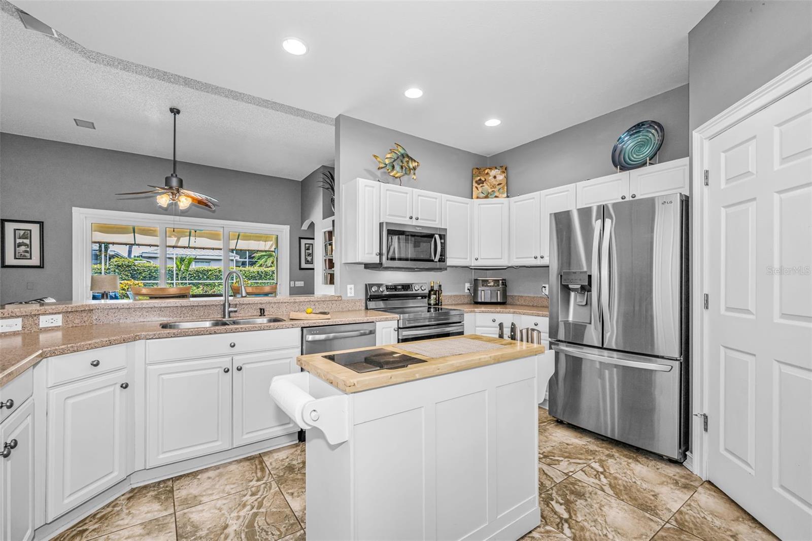 Kitchen overlooks great room with a breakfast bar
