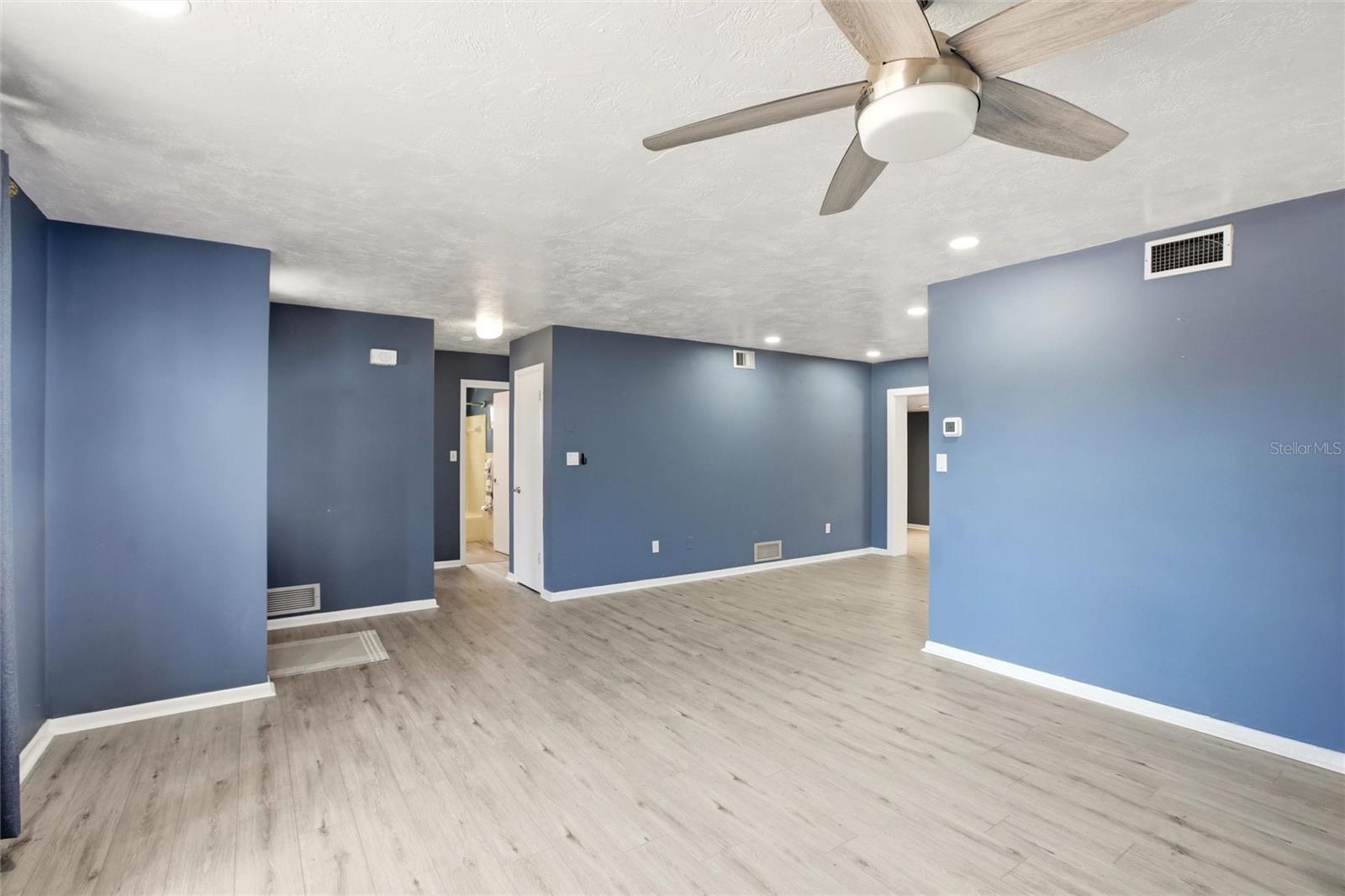 View from living area to hallway closets, bedrooms and bathroom