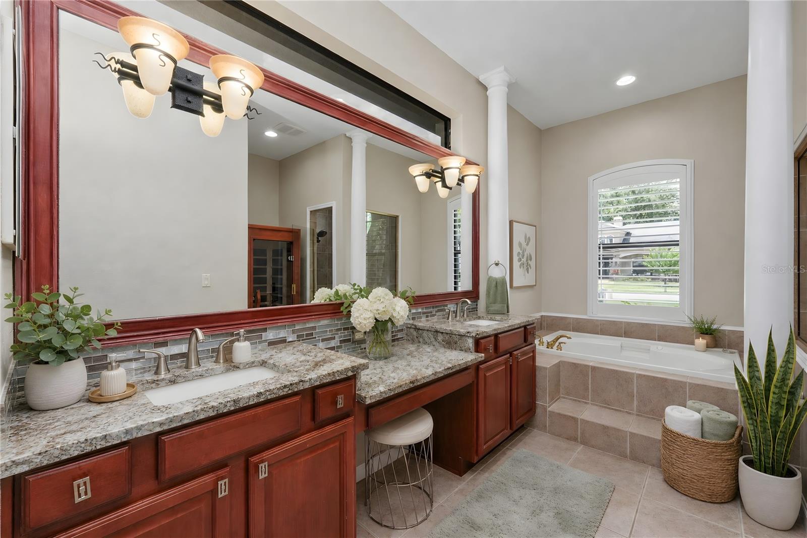 Primary Bathroom with quartz countertops, dual sinks and