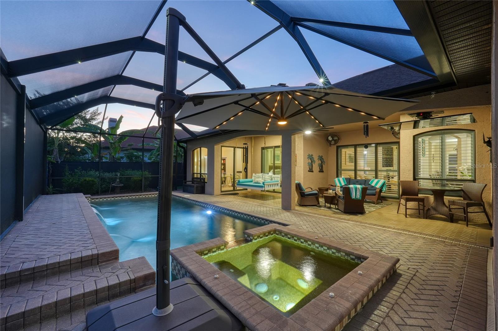 Heated pool and dedicated spa with water features and lots of covered lanai space