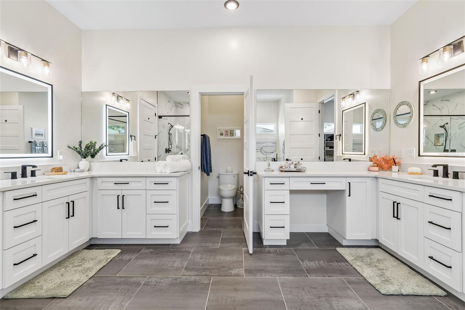 Primary bathroom with separate dual vanities