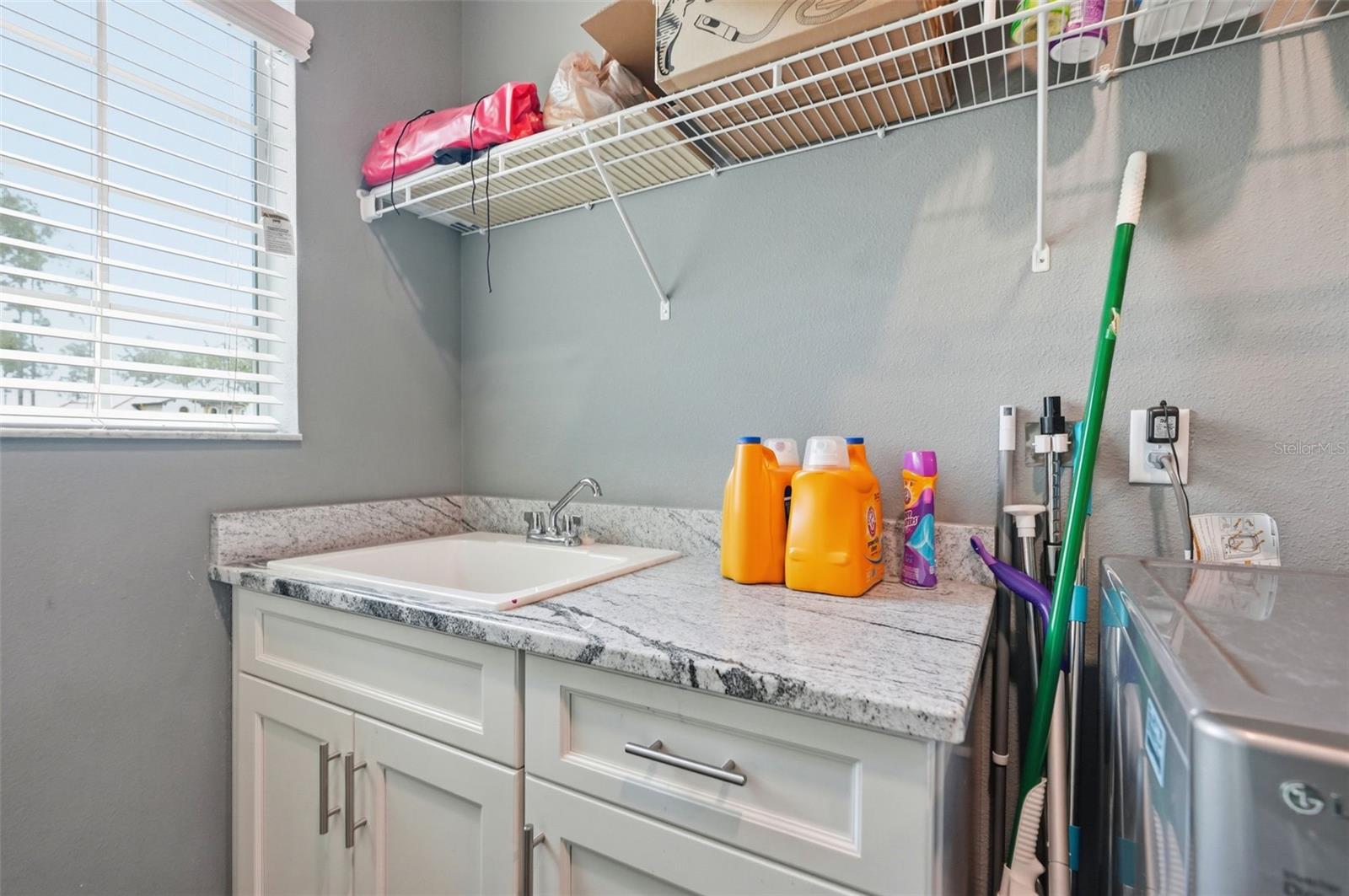 Granite countertops in the laundry room with sink.