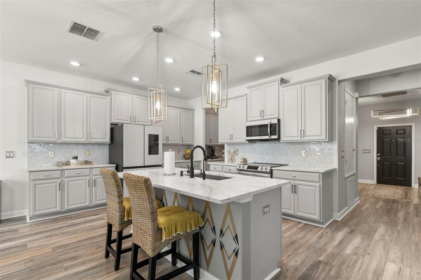 BESPOKE HIGH END APPLIANCES BY SAMSUNG Quartz countertops with plenty of cabinets