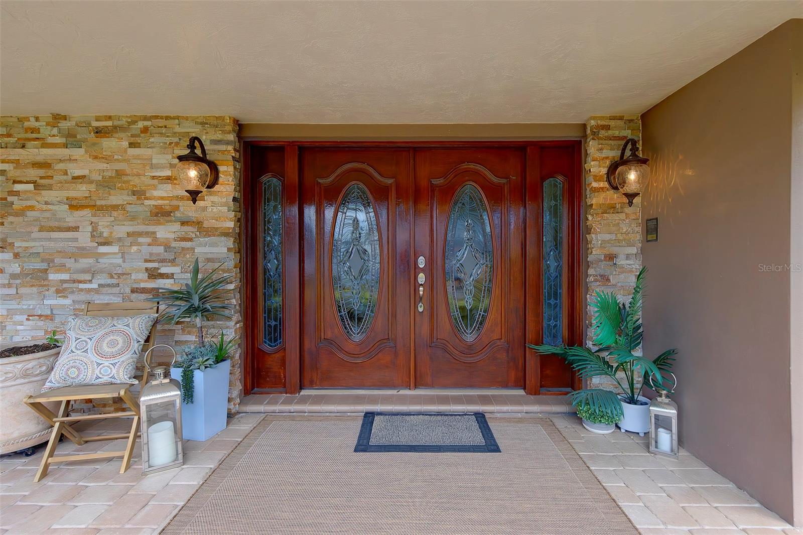 Double door entry to the home, stacked stone entrance