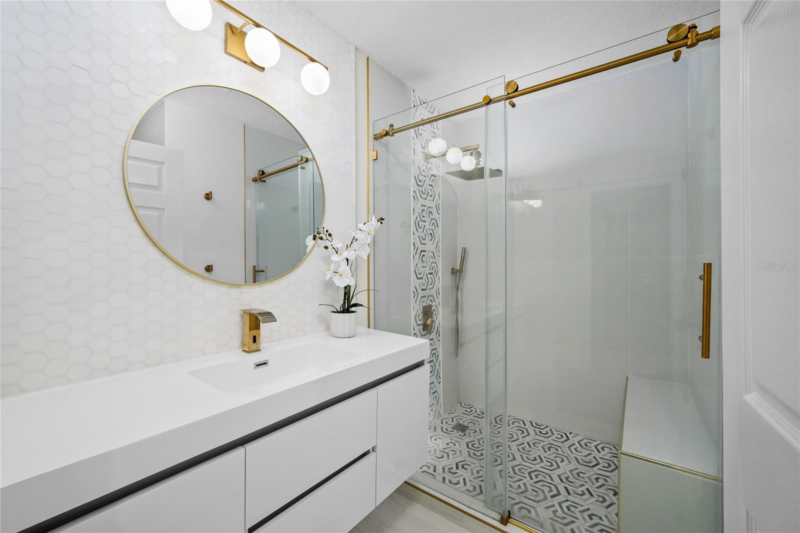 Updated guest bath with quartz countertops and designer finishes