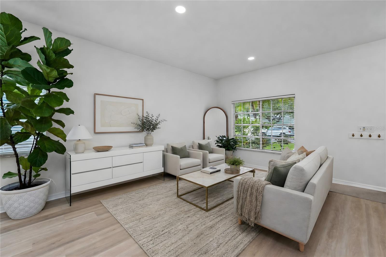 Light-filled living space with updated flooring and seamless flow