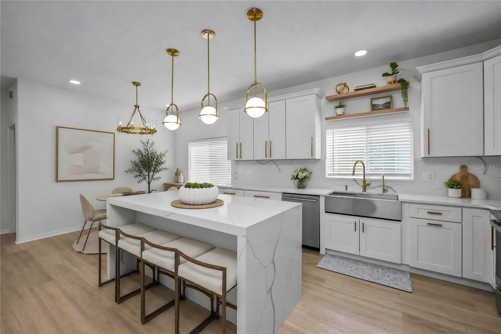 Designer kitchen with waterfall-edge quartz island and open layout