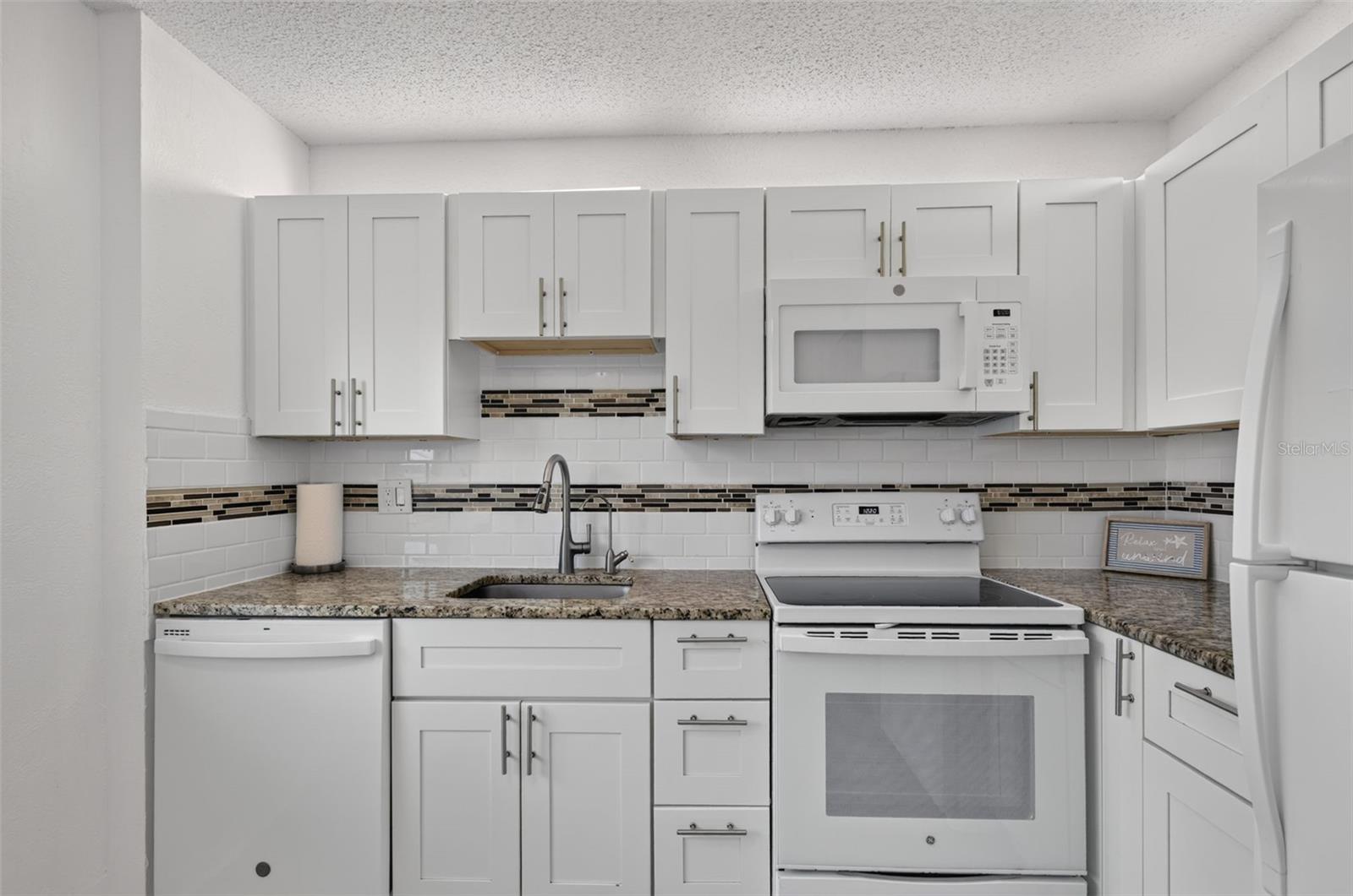 Everything you need is here. Easy clean backsplash, Over cabinet lighting