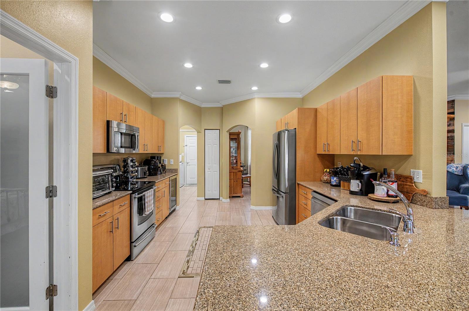 Granite Countertops, Crown molding, Stainless Steel Appliances and tile flooring.