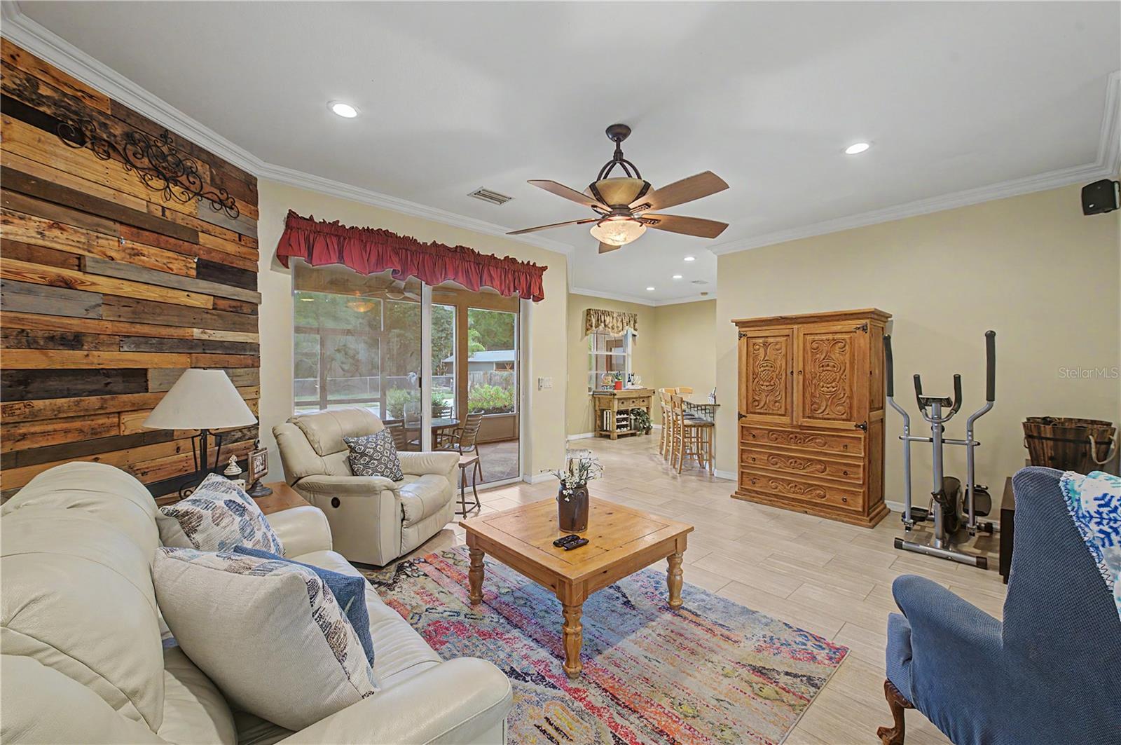 Family Room, tile flooring and ceiling fan, inset lights.