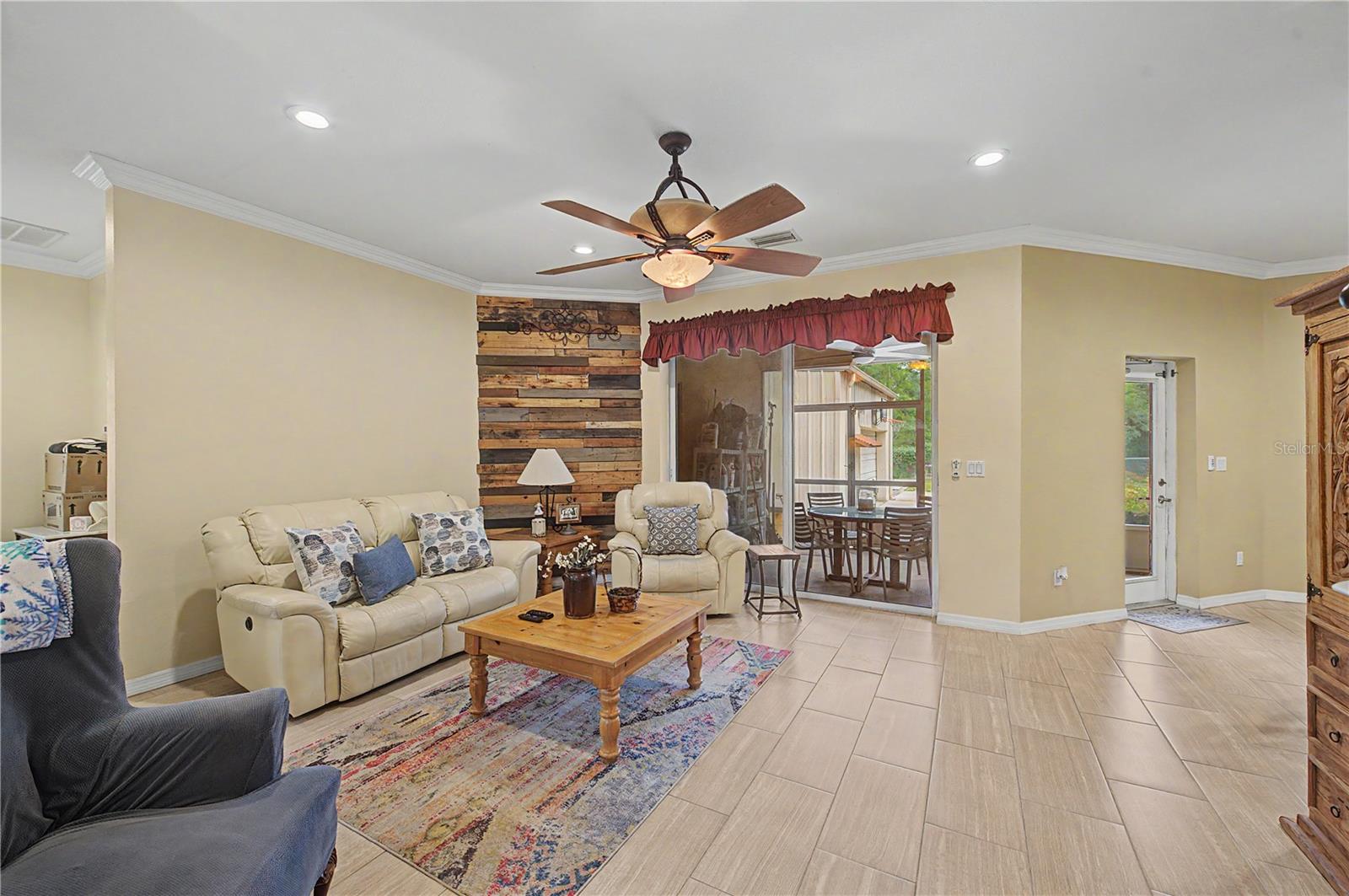 Family Room, tile flooring and ceiling fan, inset lights.