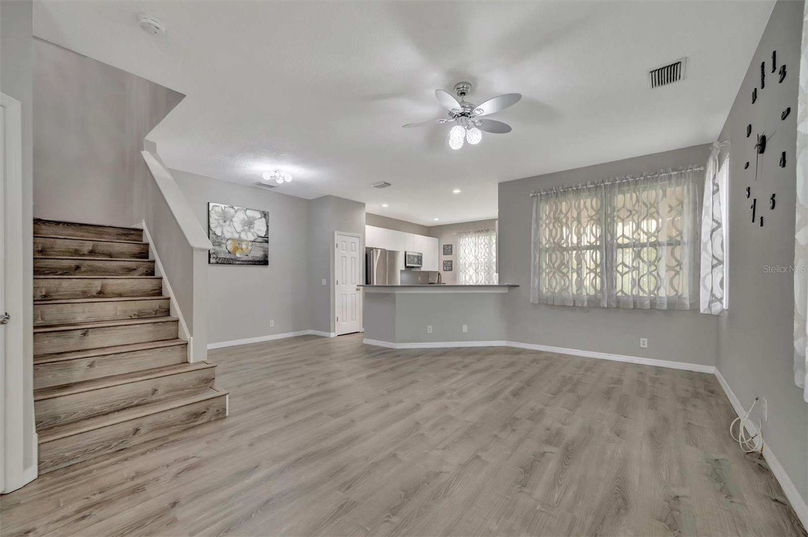 Front Entrance leading to the Living Room, half bath to the left of the stairs