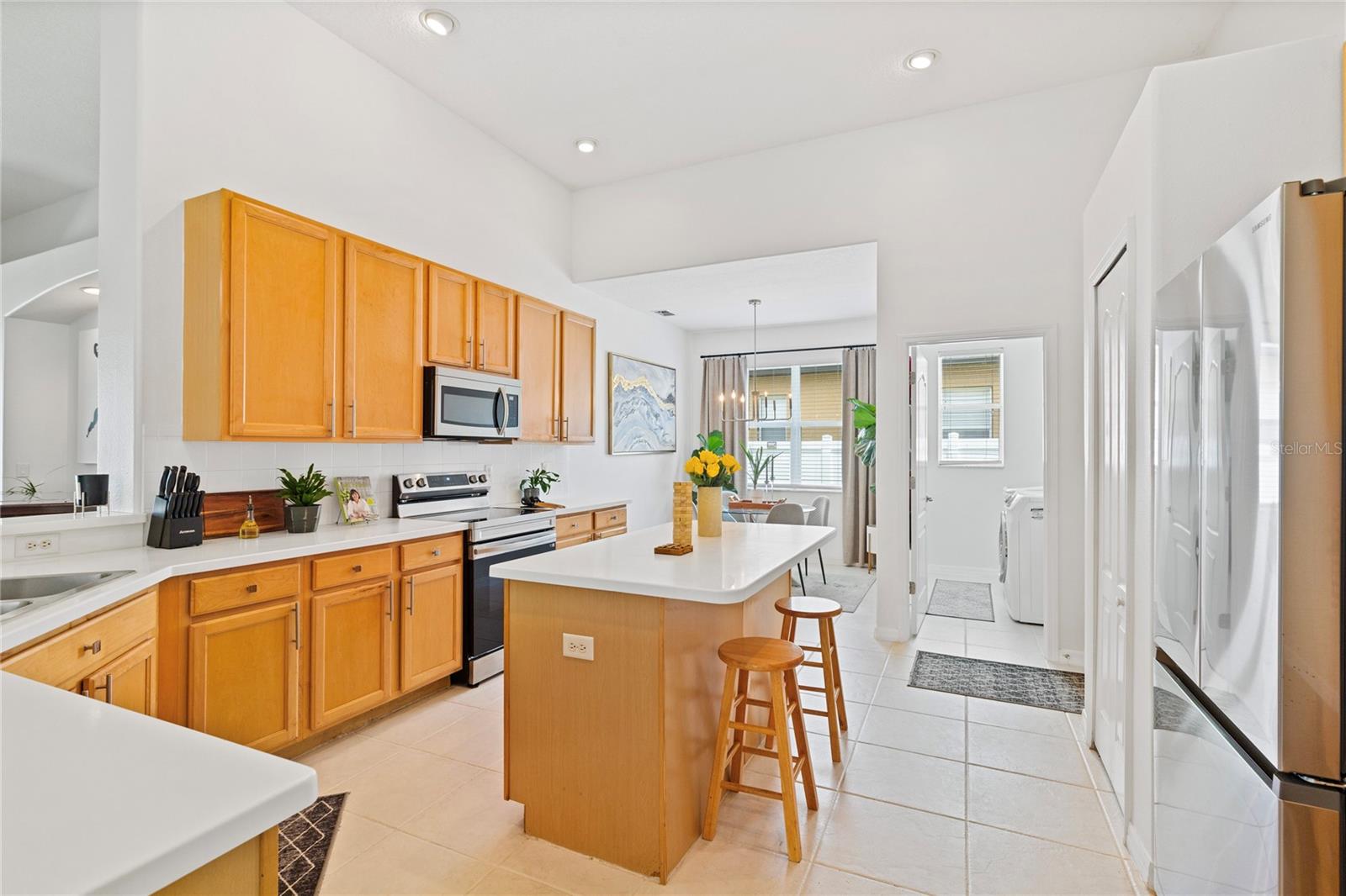 Kitchen contains lots of cabinets and Island for prep space and additional seating